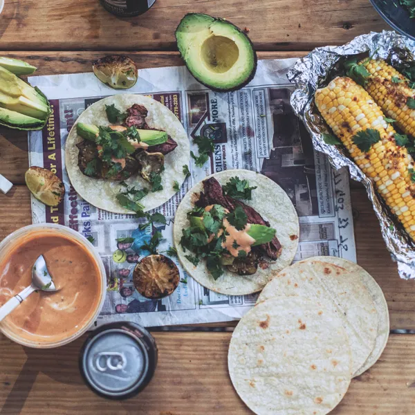 Smoky Mexican beef tacos and chili lime corn over the campfire